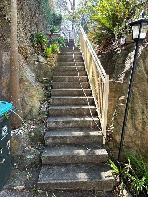 Resurfaced exterior concrete stairs in a landscaped garden